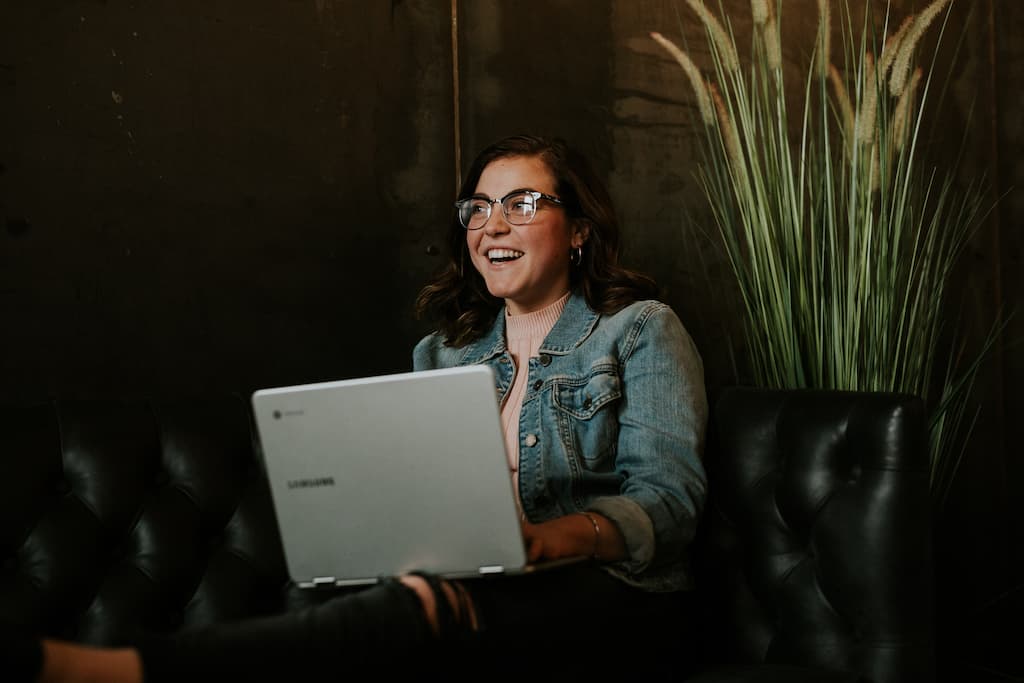 Smiling young person with laptop